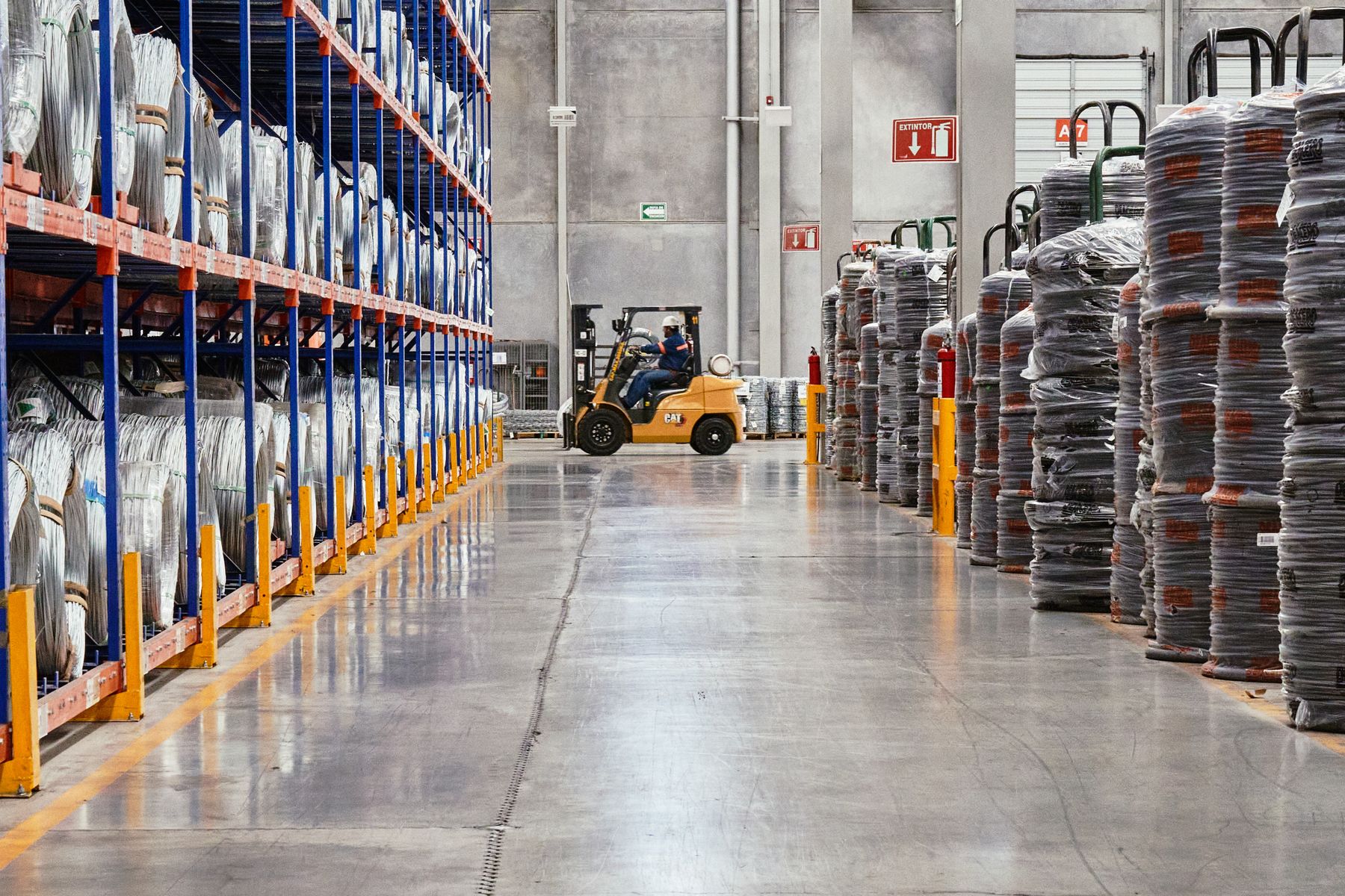 A forklift operator moving cargo in a warehouse